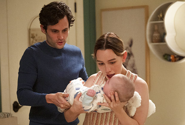 Victoria Pedretti as Love Quinn and Penn Badgley as Joe Goldberg with a baby