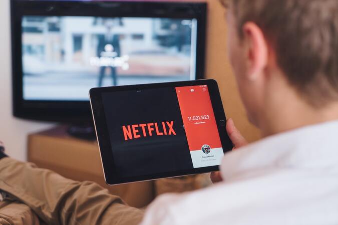 man-watching-netflix-on-tablet