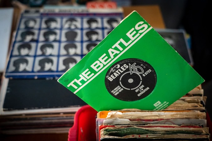 The single Hey Jude, by The Beatles, with the album, A Hard Days Night in the background.